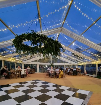 Clear roof marquee at dusk with fairy lights and dance floor